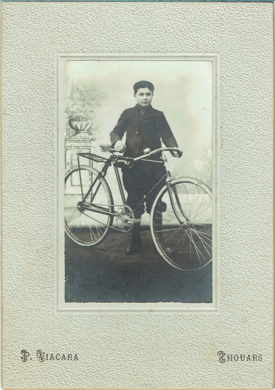 Grand garçon posant en atelier avec sa bicyclette