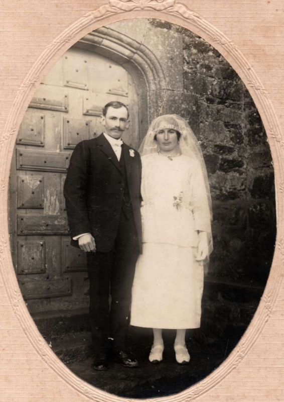 Mariés posant devant la porte de l'église
