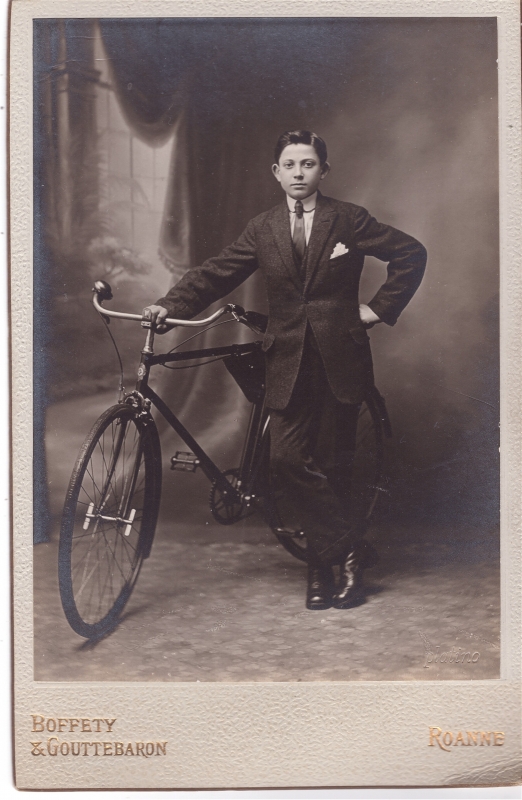 Adolescent posant en atelier à côté de sa bicyclette