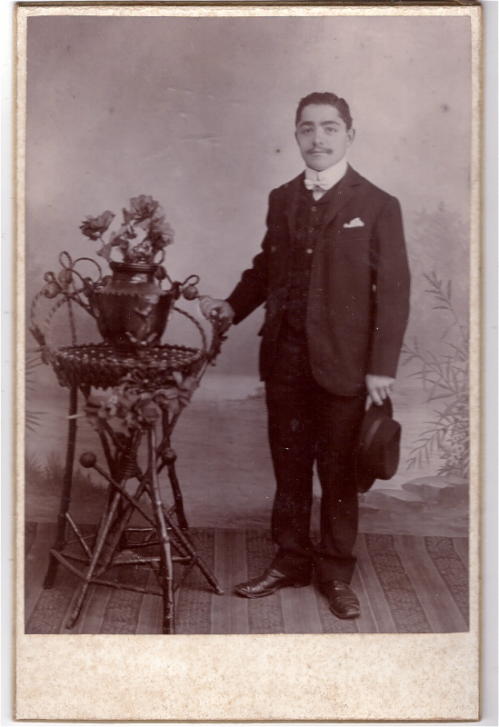 Jeune homme posant à côté d'une belle composition florale