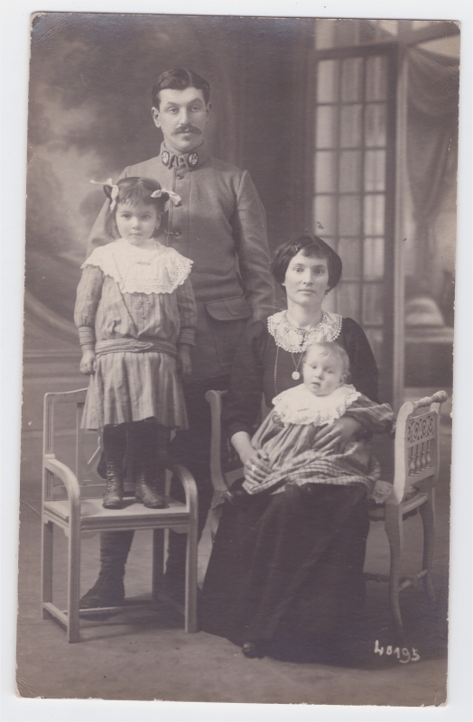 Parents -le père en uniforme- posant avec leurs deux enfants